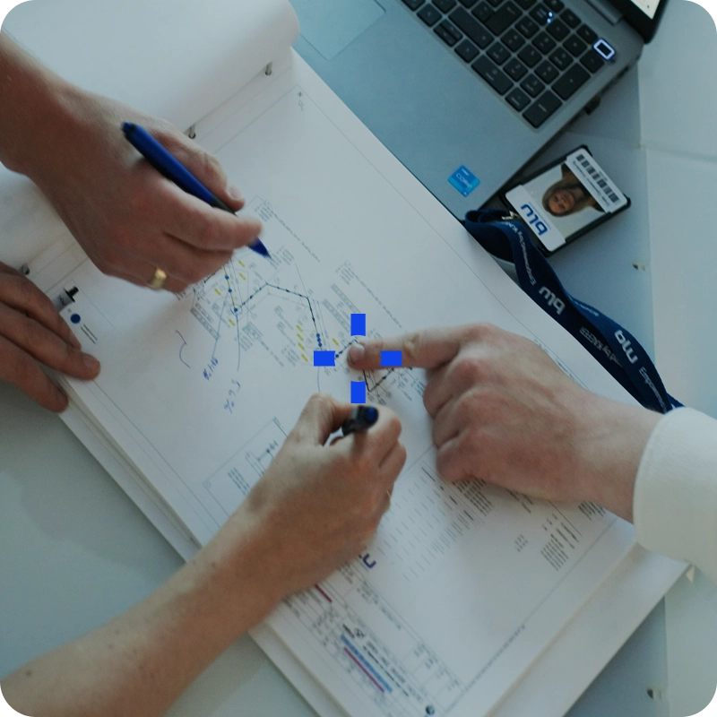 Engineers reviewing piping and instrumentation diagrams during an asset integrity inspection