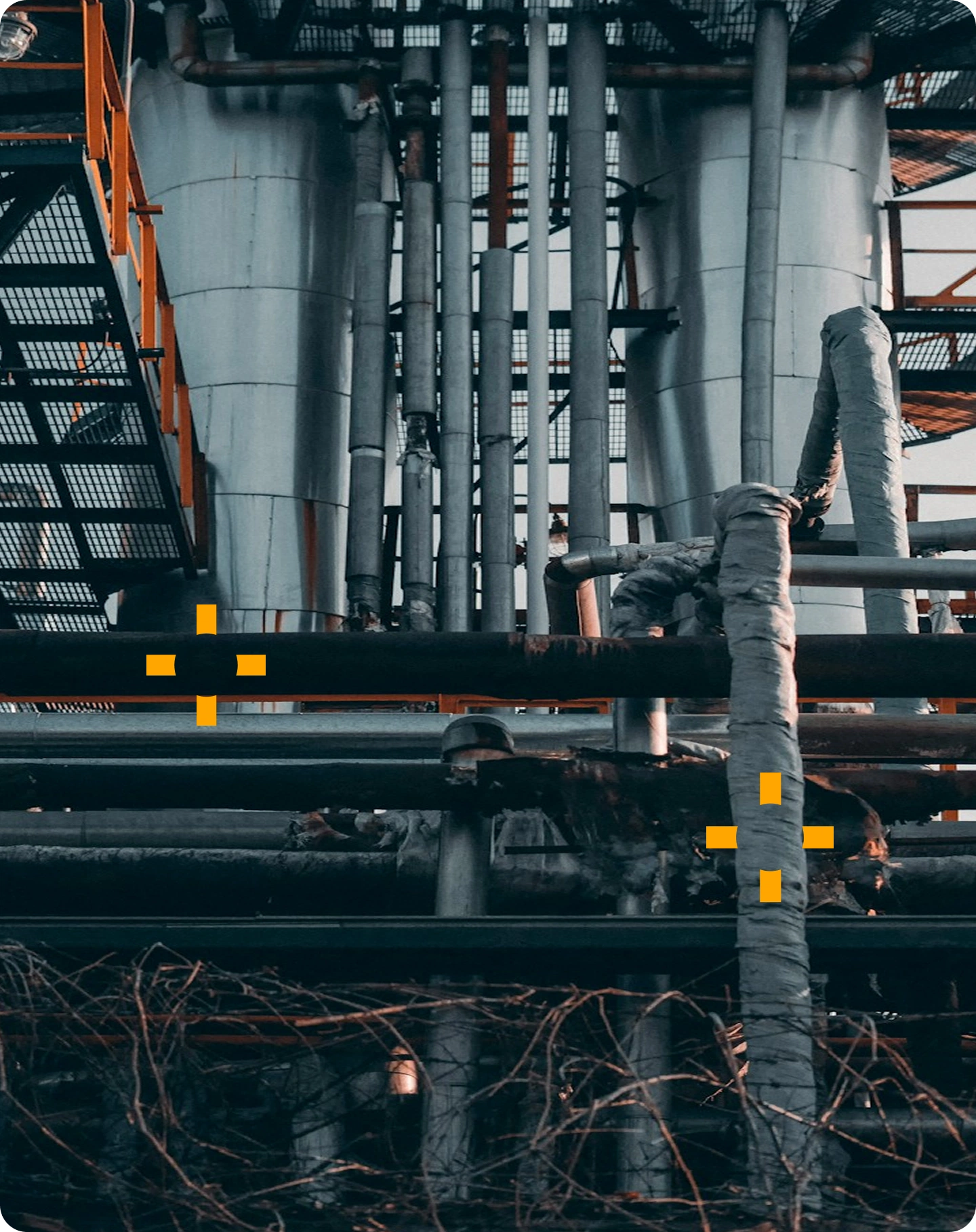 Weathered pipework and insulation at an industrial facility showing corrosion under insulation risk